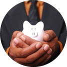 Photo of man's hands cradling a small white piggy bank.